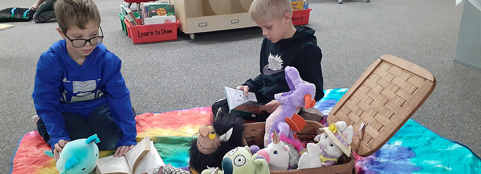 Students choose a book and sit down for a picnic with a pal.